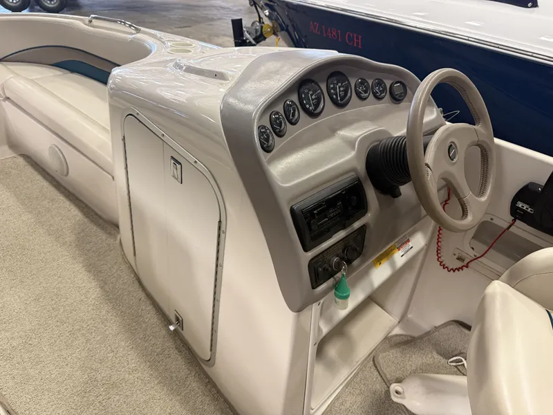 Slide: The Image of The image shows the cockpit of a 1996 Chaparral 210 Sunesta with a gray dashboard. - 21