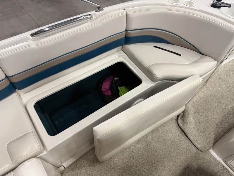 Slide: The Image of Interior view of a 1996 Chaparral 210 Sunesta with an open bench seat and storage compartment. - 18