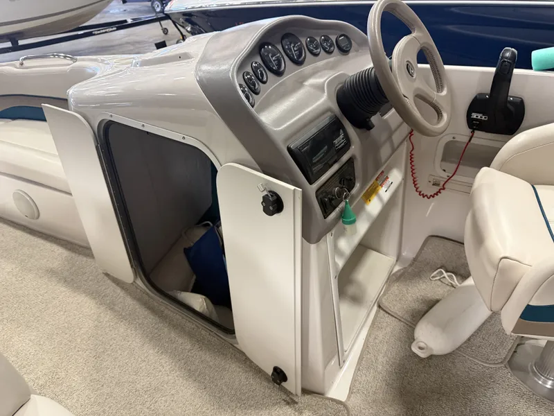 Slide: The Image of The image shows the cockpit of a 1996 Chaparral 210 Sunesta with a helm and instruments. - 22