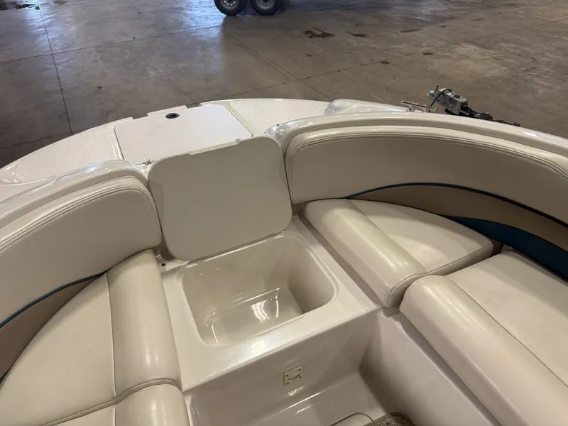 Slide: The Image of The image shows the bow area of a 1996 Chaparral 210 Sunesta boat with white upholstery. - 34