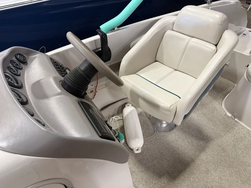 Slide: The Image of Interior view of a 1996 Chaparral 210 Sunesta with a beige steering wheel and cushioned seat. - 20