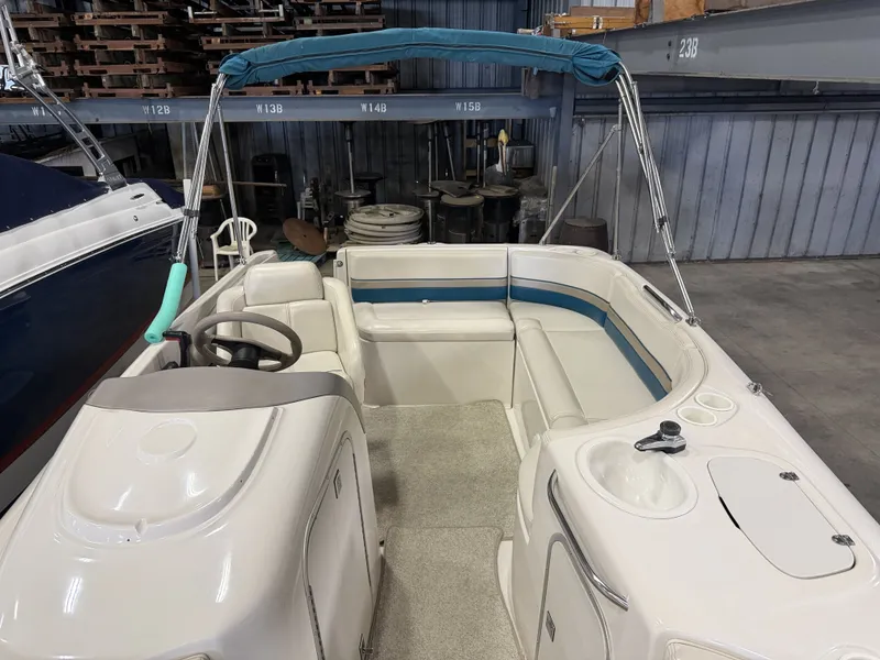 Slide: The Image of The image shows the cockpit of a 1996 Chaparral 210 Sunesta. It features white upholstery and a blue sunshade. - 15
