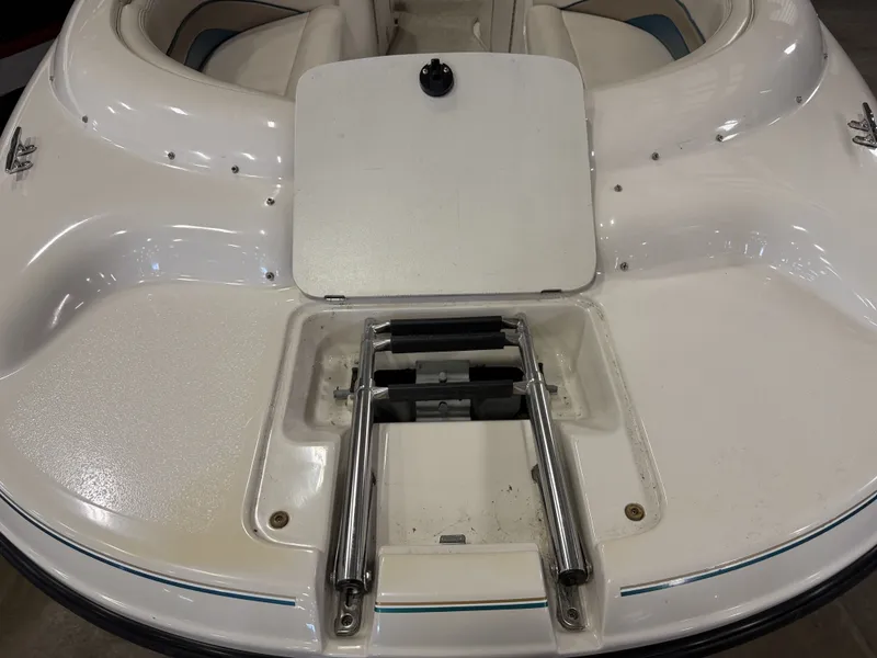 Slide: The Image of The image shows the bow deck of a Chaparral 210 Sunesta boat with a retractable ladder. - 12