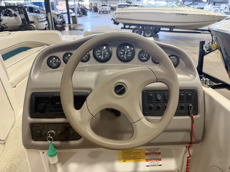 Slide: The Image of The image shows the cockpit of a 1996 Chaparral 210 Sunesta with a steering wheel and instruments. - 23