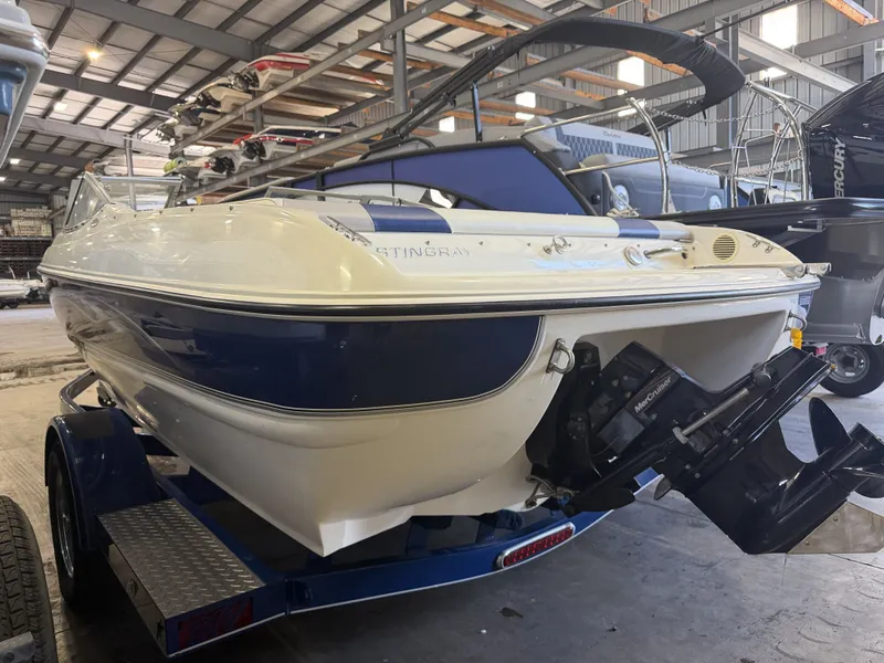 Slide: The Image of A 2006 Stingray 195 LX boat on a trailer in a storage facility. - 3