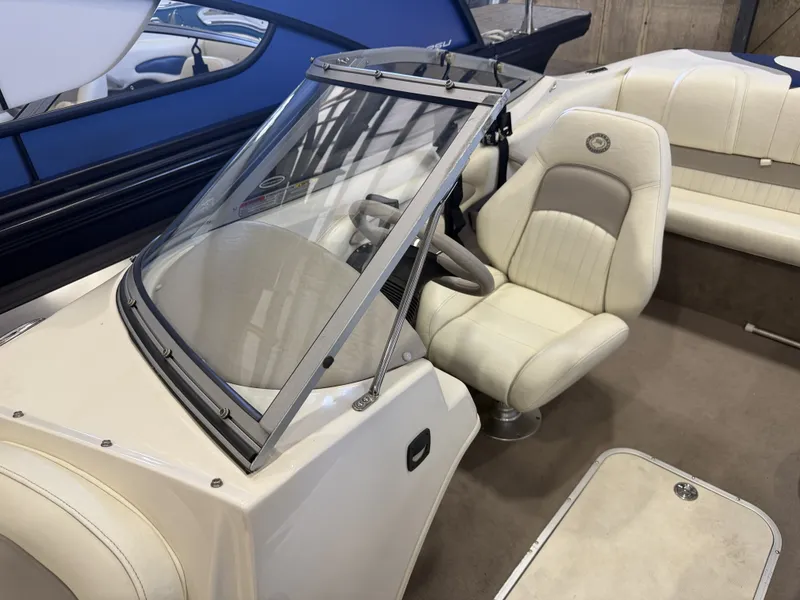 Slide: The Image of Interior of a 2006 Stingray 195 LX with beige seats and steering wheel. - 15