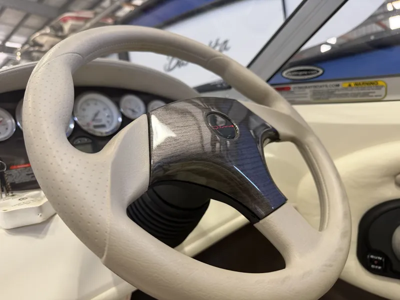 Slide: The Image of Close-up of a 2006 Stingray 195 LX steering wheel with wood trim and instrument display. - 19