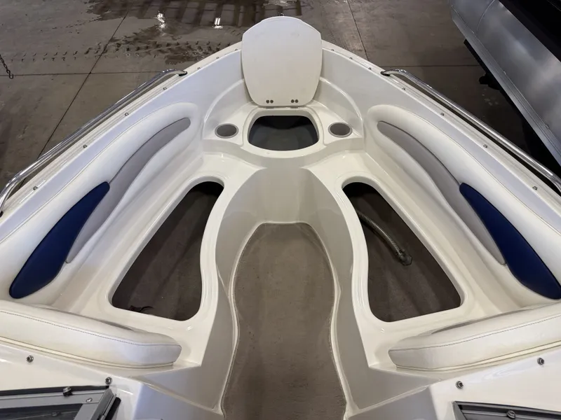 Slide: The Image of The image shows the bow of a 2006 Stingray 195 LX with white and blue upholstery. - 24
