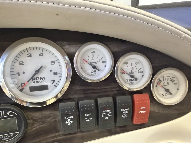 Slide: The Image of Dashboard of a boat with various gauges and switches. - 18