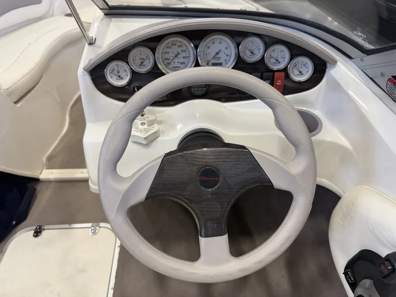 Slide: The Image of The image shows the helm of a 2006 Stingray 195 LX with multiple instrument gauges. - 39