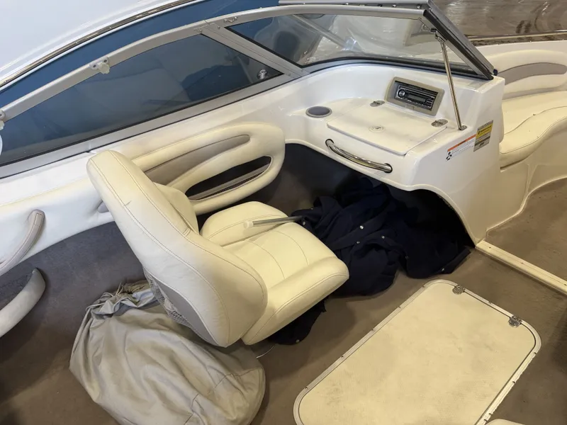 Slide: The Image of Interior of a 2006 Stingray 195 LX with white leather seats and a helm station. - 13