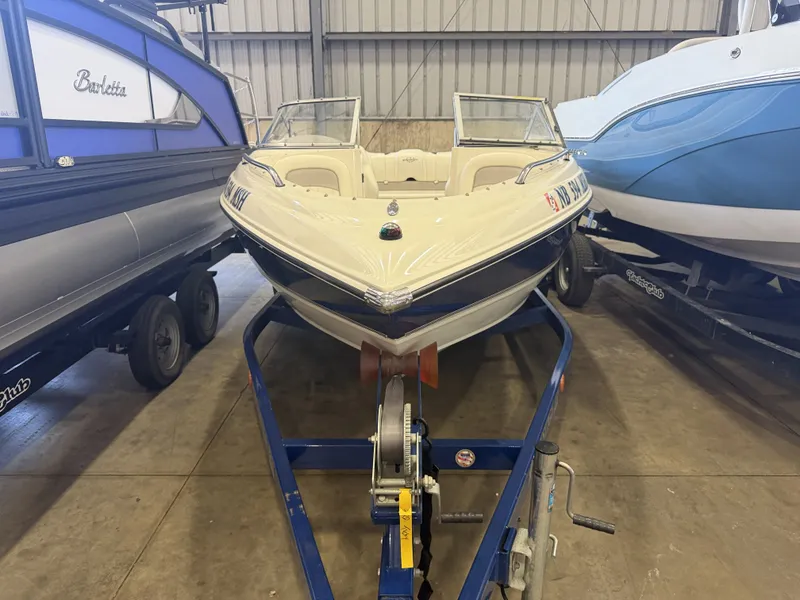 Slide: The Image of A 2006 Stingray 195 LX boat is on a trailer in a storage facility. - 2