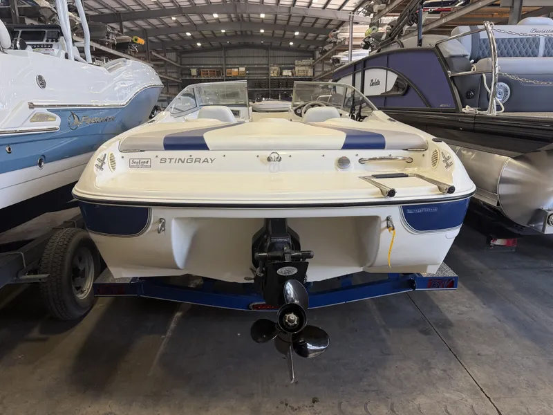 Slide: The Image of A 2006 Stingray 195 LX boat is on a trailer in a storage facility. - 4