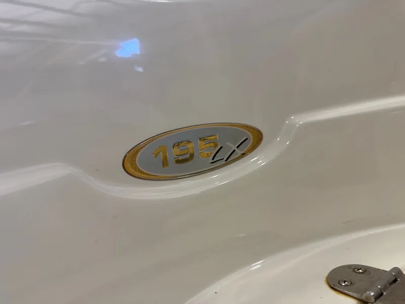 Slide: The Image of Close-up of the 195 LX logo on a white boat hull. - 30