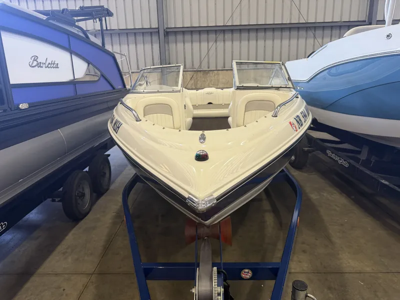 Slide: The Image of A white 2006 Stingray 195 LX is on a trailer in a warehouse. - 33