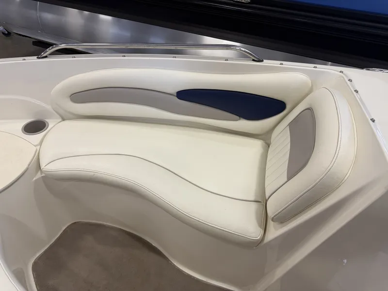 Slide: The Image of A sleek, white seating area with blue and gray accents in a boat. - 26