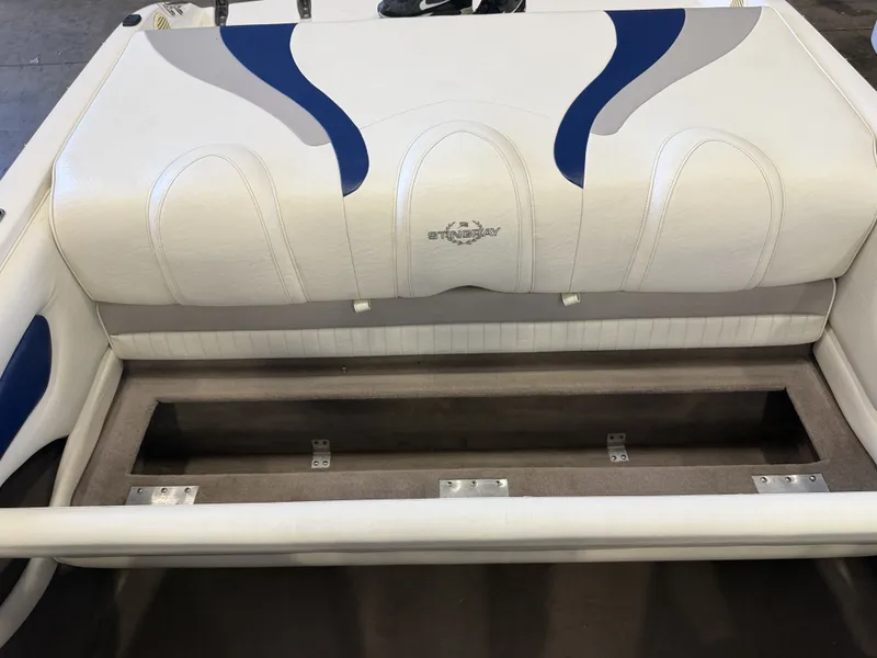 Slide: The Image of Rear seat of a 2006 Stingray 195 LX with white and blue upholstery and storage underneath. - 37