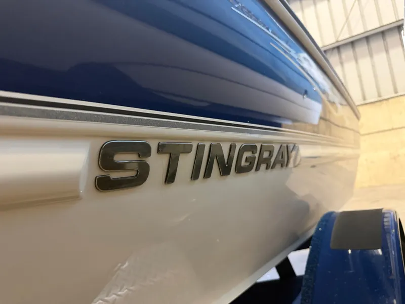 Slide: The Image of Close-up of the "Stingray" lettering on a blue and white boat. - 7