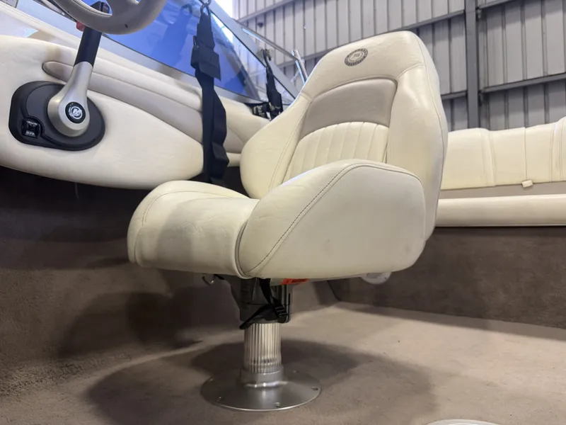 Slide: The Image of Interior view of a boat with a beige captain's chair and steering wheel. - 20