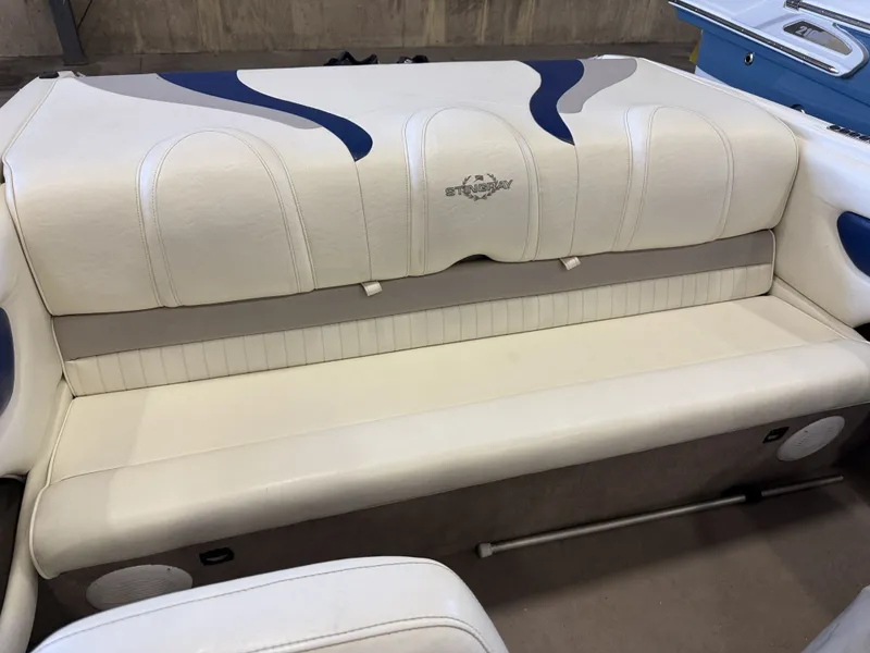 Slide: The Image of The rear seat of a 2006 Stingray 195 LX with white upholstery and blue accents. - 36