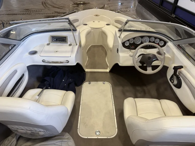Slide: The Image of The image shows the cockpit of a 2006 Stingray 195 LX with white leather seats and dashboard. - 12