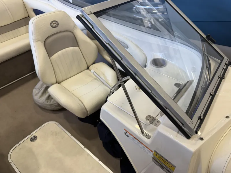 Slide: The Image of Interior view of a boat with beige seating and a helm console. - 14
