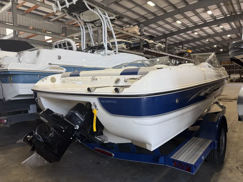 Slide: The Image of A 2006 Stingray 195 LX boat on a trailer in a storage facility. - 5