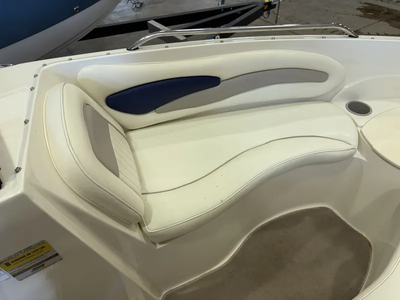 Slide: The Image of The image shows a white seat with blue accents on a boat. - 25