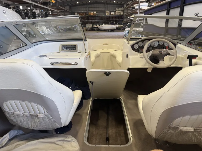 Slide: The Image of Interior view of a 2006 Stingray 195 LX with white seats and dashboard. - 40