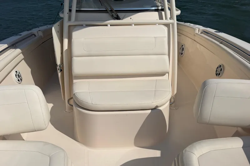 Slide: The Image of 2019 Grady-White Canyon 336 boat interior with white seating and ocean backdrop. - 20