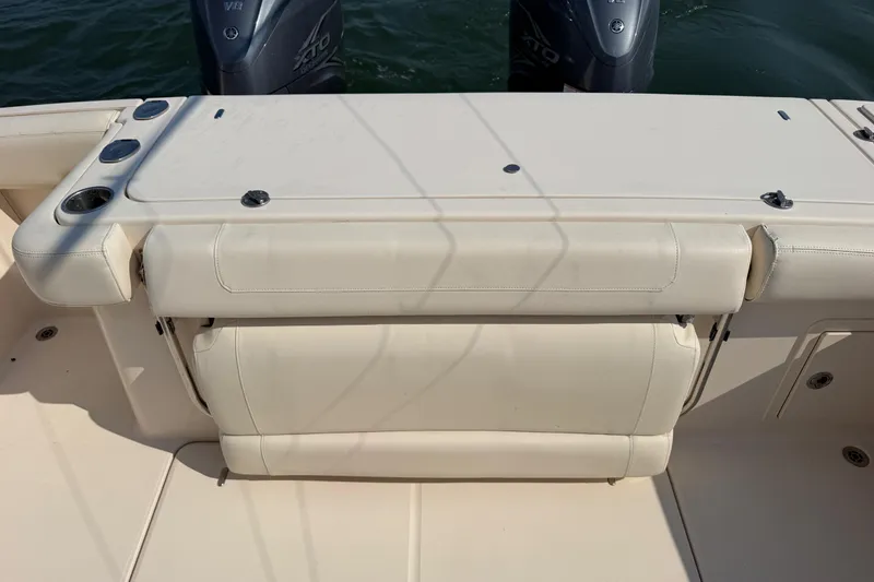 Slide: The Image of 2019 Grady-White Canyon 336 boat with dual outboard motors and cushioned seating. - 62