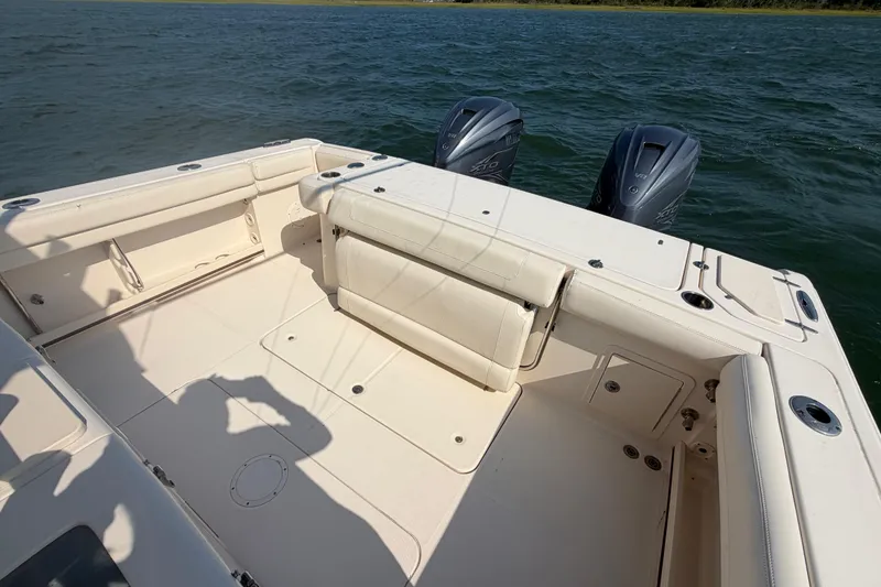 Slide: The Image of 2019 Grady-White Canyon 336 boat deck with dual outboard motors on water. - 52