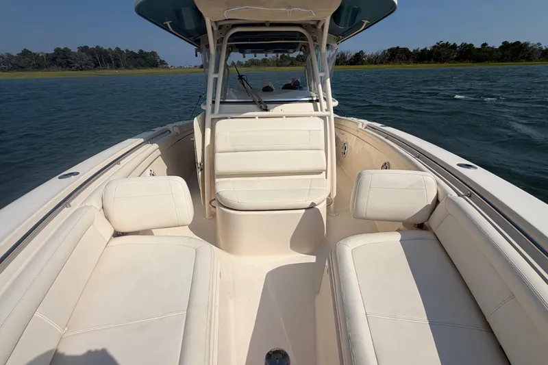 Slide: The Image of 2019 Grady-White Canyon 336 boat interior with white seating on open water. - 21
