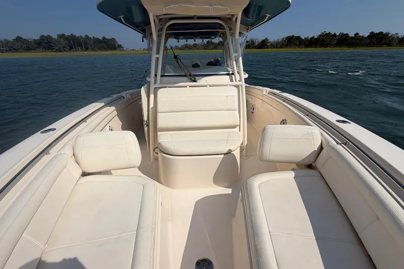 Slide: The Image of 2019 Grady-White Canyon 336 boat interior with white seating on open water. - 23