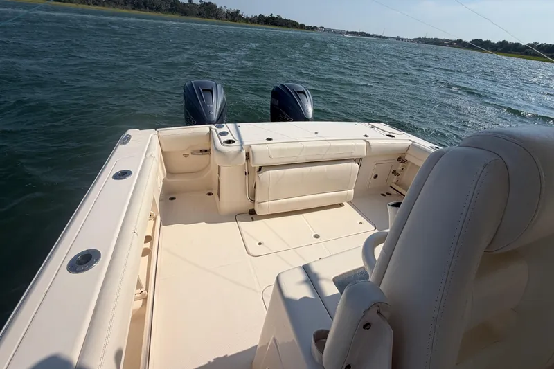 Slide: The Image of 2019 Grady-White Canyon 336 boat interior with dual outboard motors on open water. - 43