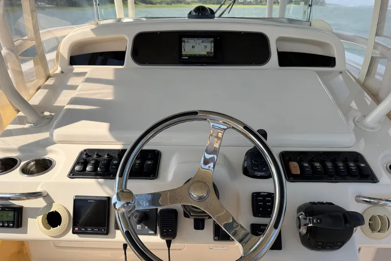 Slide: The Image of 2019 Grady-White Canyon 336 helm with steering wheel and control panel. - 37
