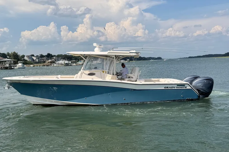 The Image of 2019 Grady-White Canyon 336 boat cruising on a calm, scenic waterway. - 0