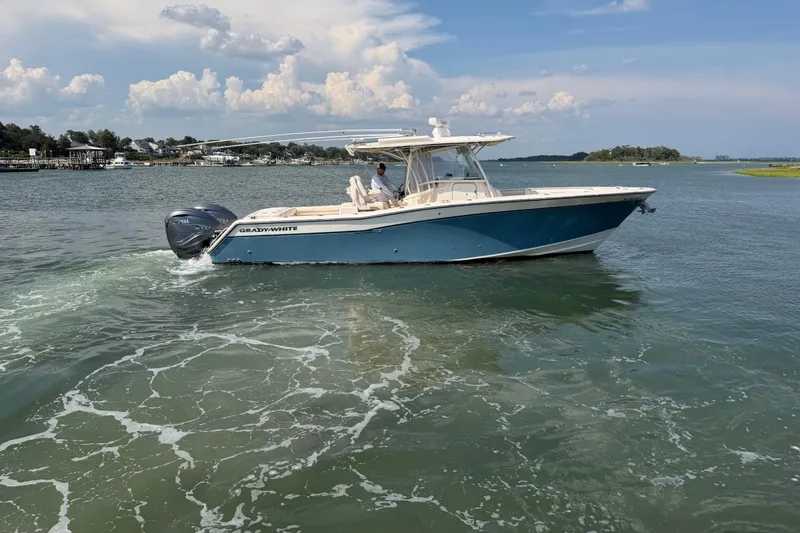 Slide: The Image of 2019 Grady-White Canyon 336 boat cruising on a scenic waterway. - 1