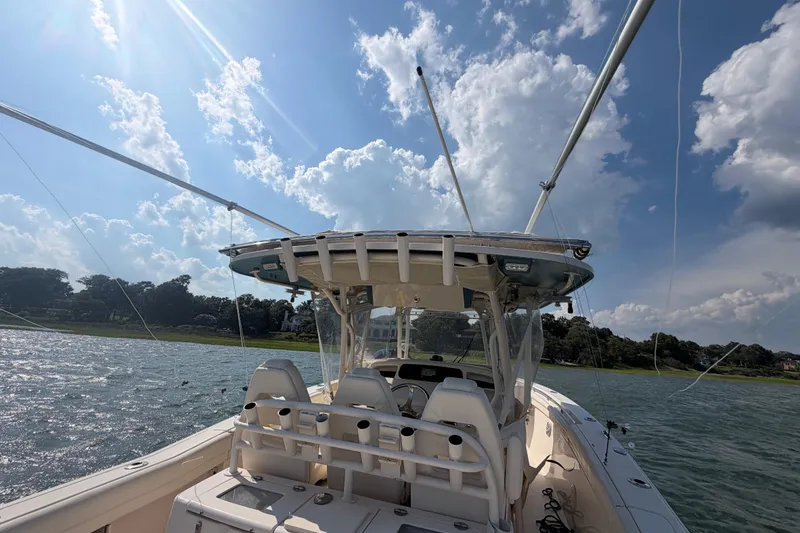 Slide: The Image of 2019 Grady-White Canyon 336 boat cruising on a sunny day with scenic shoreline. - 59