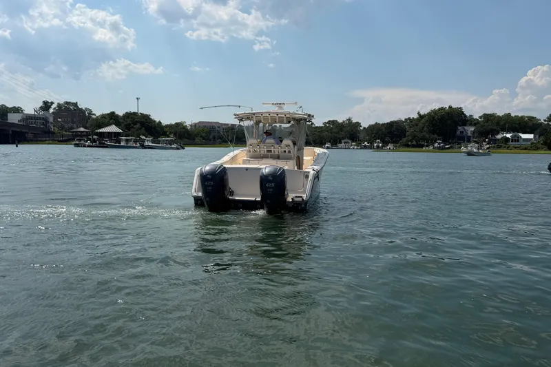 Slide: The Image of 2019 Grady-White Canyon 336 boat cruising on a sunny day in a scenic waterway. - 18