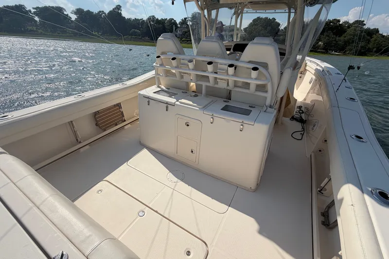 Slide: The Image of 2019 Grady-White Canyon 336 boat interior with seating and storage, on a sunny day. - 58