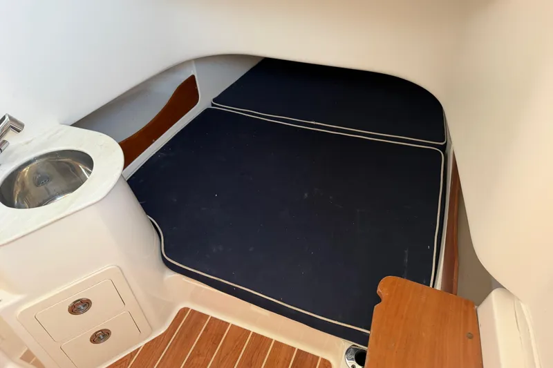 Slide: The Image of 2019 Grady-White Canyon 336 cabin interior with sink and cushioned seating area. - 30