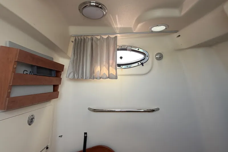Slide: The Image of Interior of 2019 Grady-White Canyon 336 boat with porthole and curtain. - 35