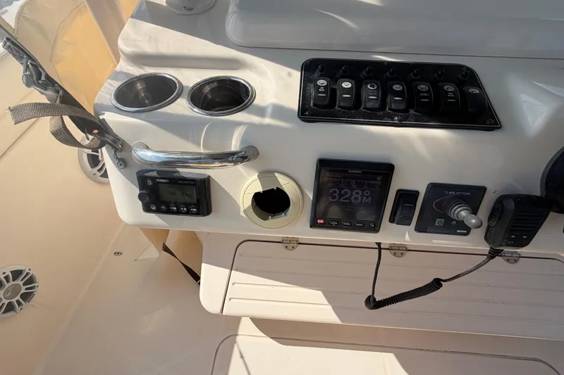 Slide: The Image of Control panel of a 2019 Grady-White Canyon 336 boat with electronic displays and switches. - 42