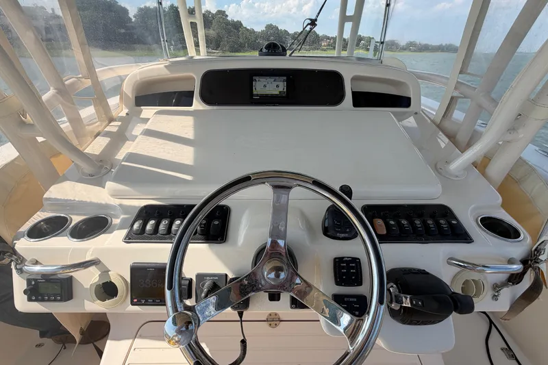 Slide: The Image of 2019 Grady-White Canyon 336 boat helm with steering wheel and control panel. - 46