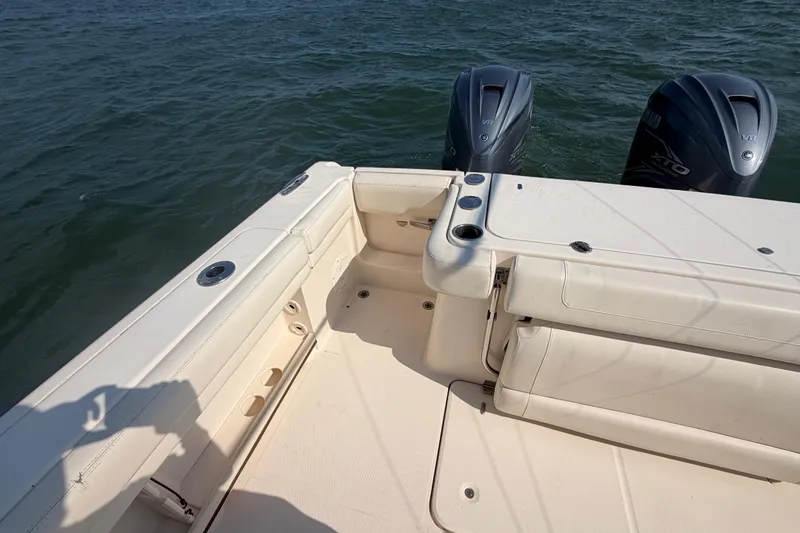 Slide: The Image of 2019 Grady-White Canyon 336 boat deck with twin Yamaha V8 engines on water. - 55