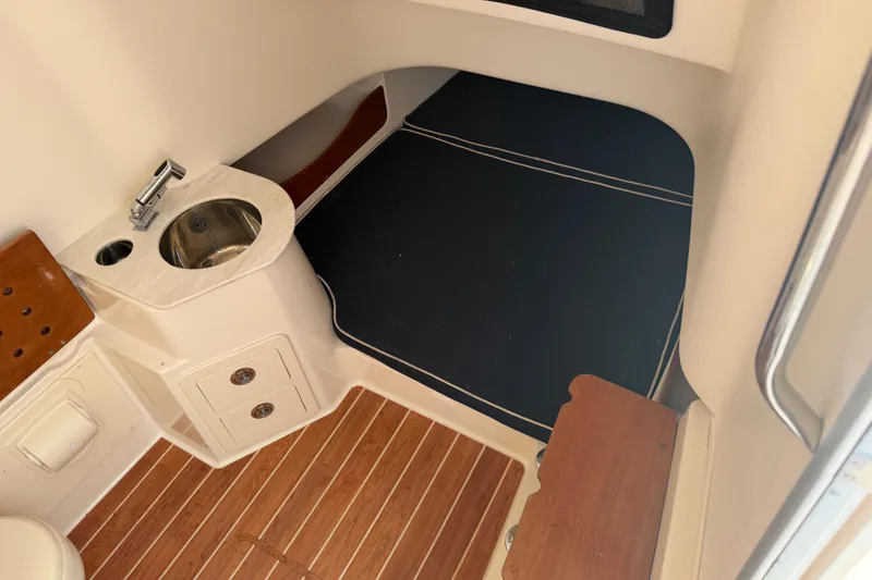 Slide: The Image of 2019 Grady-White Canyon 336 cabin interior with sink and wooden flooring. - 28
