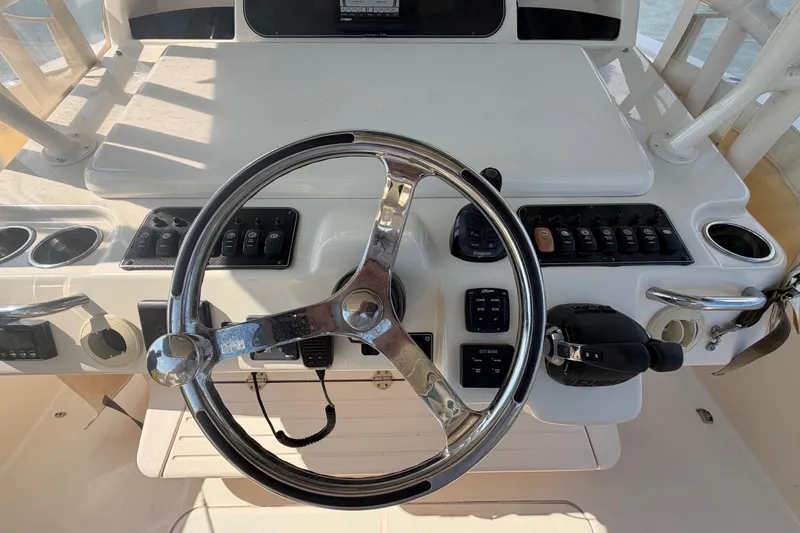 Slide: The Image of Steering console of 2019 Grady-White Canyon 336 boat with controls and switches. - 39