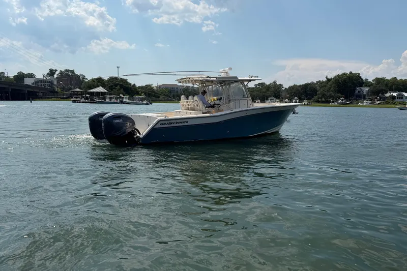 Slide: The Image of 2019 Grady-White Canyon 336 boat cruising on a sunny day in calm waters. - 15
