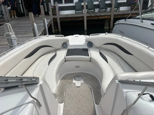Slide: The Image of The image shows the cockpit of a 2011 Starcraft 2210 boat with white cushioned seating. - 11